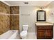 Bathroom featuring a shower-tub combo, granite vanity and updated fixtures at 8922 Donna Lu Dr, Odessa, FL 33556