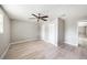 Bright bedroom featuring wood-look floors, neutral walls, ceiling fan and two closets for ample storage at 8922 Donna Lu Dr, Odessa, FL 33556