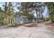 Charming single-story home featuring light blue siding, flower boxes, and a spacious front yard area at 8922 Donna Lu Dr, Odessa, FL 33556