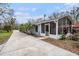 Charming single-story home featuring light blue siding, palm trees and a screened in porch at 8922 Donna Lu Dr, Odessa, FL 33556