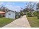 Charming single-story home featuring light blue siding, a spacious front yard and mature landscaping at 8922 Donna Lu Dr, Odessa, FL 33556