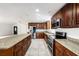 Updated kitchen boasts stainless steel appliances, granite countertops and wooden cabinetry at 8922 Donna Lu Dr, Odessa, FL 33556