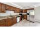 Kitchen featuring stainless steel appliances, granite countertops and wood cabinets at 8922 Donna Lu Dr, Odessa, FL 33556