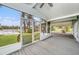 Screened porch with views of the lake and surrounding greenery, offering a serene outdoor space at 8922 Donna Lu Dr, Odessa, FL 33556
