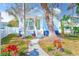 Charming home showcasing a light blue exterior, welcoming porch, and beautifully landscaped yard with stone pathway at 112 17Th E St, Bradenton, FL 34208