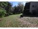 Lush backyard with a large tree and landscaping at 11723 Raintree Village Blvd # B, Temple Terrace, FL 33617