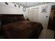 The bedroom has a brown bed, blinds and a wardrobe at 11723 Raintree Village Blvd # B, Temple Terrace, FL 33617