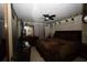 Cozy bedroom featuring dark wood furniture, ceiling fan, and wall decorations at 11723 Raintree Village Blvd # B, Temple Terrace, FL 33617