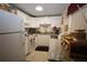 Efficient kitchen with white cabinets and appliances, and a breakfast bar at 11723 Raintree Village Blvd # B, Temple Terrace, FL 33617