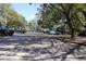 Parking lot area with multiple vehicles and trees at 11723 Raintree Village Blvd # B, Temple Terrace, FL 33617