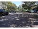 A spacious parking lot is shaded by mature trees, providing ample parking for residents and guests at 11723 Raintree Village Blvd # B, Temple Terrace, FL 33617