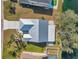 Top down view of a house featuring lush landscaping and waterfront access to a serene lake at 1204 50Th E St, Bradenton, FL 34208
