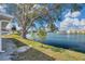 A serene lake view from the backyard, enhanced by mature trees and well-maintained landscaping at 1204 50Th E St, Bradenton, FL 34208