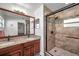 Bathroom features a double vanity with granite countertop and a walk-in shower at 1204 50Th E St, Bradenton, FL 34208