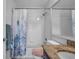 Full bathroom with tiled shower, granite countertop, and a shower curtain at 1204 50Th E St, Bradenton, FL 34208