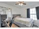 Comfortable bedroom features a ceiling fan, window, and closet with mirrored doors at 1204 50Th E St, Bradenton, FL 34208