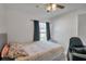 Bright bedroom with a ceiling fan, neutral walls, and window with dark curtains at 1204 50Th E St, Bradenton, FL 34208