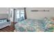 Comfortable bedroom with a view to the screened patio and a serene water view at 1204 50Th E St, Bradenton, FL 34208