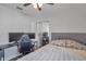 Cozy bedroom with dual monitors, ceiling fan, closet, and laminate wood flooring at 1204 50Th E St, Bradenton, FL 34208