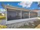Back of house displaying enclosed patio, perfect for enjoying outdoor living and entertainment at 1204 50Th E St, Bradenton, FL 34208