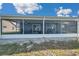Rear exterior showcasing the screened lanai, providing a relaxing space to enjoy the beautiful surroundings at 1204 50Th E St, Bradenton, FL 34208