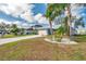 Beautiful landscaped yard featuring a single Gathering home with a metal roof and palm trees at 1204 50Th E St, Bradenton, FL 34208