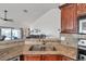 Granite countertops highlight a stainless steel sink, with views of the open-concept living area and serene lake at 1204 50Th E St, Bradenton, FL 34208