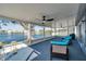 Enjoy serene lake views from this covered lanai with comfortable seating and ceiling fans at 1204 50Th E St, Bradenton, FL 34208