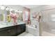 Bright bathroom featuring double sinks, soaking tub, and glass shower at 13218 Satin Lily Dr, Riverview, FL 33579