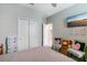 Bedroom with comfortable seating, plush bedding, and closet space at 13218 Satin Lily Dr, Riverview, FL 33579