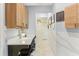Hallway with a workspace featuring stylish cabinets, decor, and modern lighting at 13218 Satin Lily Dr, Riverview, FL 33579