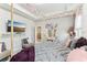 Bright primary bedroom featuring decor, large television, and a make-up vanity at 13218 Satin Lily Dr, Riverview, FL 33579