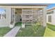 Covered patio with artificial turf, string lights, and privacy lattice at 13218 Satin Lily Dr, Riverview, FL 33579