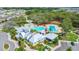 Community clubhouse featuring a swimming pool, splash pad, and well-maintained landscaping at 13218 Satin Lily Dr, Riverview, FL 33579