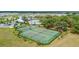 Aerial view of community tennis and basketball courts surrounded by lush green landscaping at 13218 Satin Lily Dr, Riverview, FL 33579
