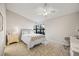 Cozy bedroom features tiled floors, a ceiling fan, and a bright window offering natural light at 14766 Feather Cove Ln, Clearwater, FL 33762