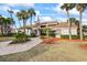 Beautiful building with lush landscaping, mature palm trees and tiled walkway to entrance at 14766 Feather Cove Ln, Clearwater, FL 33762
