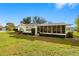 Well-maintained home with a screened porch, tidy landscaping, and green lawn at 1801 38Th N St, St Petersburg, FL 33713