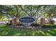 Welcome to Downtown Dunedin sign amid lush greenery with brick columns at 200 Glennes Ln # 103, Dunedin, FL 34698