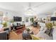 Open concept living room with light hardwood floors connecting to the dining area at 200 Glennes Ln # 103, Dunedin, FL 34698