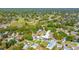 An aerial view of the property, highlighting it's proximity to a golf course, other homes, and community features at 2016 Culberson Ave, Dunedin, FL 34698