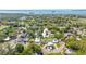 Aerial view of the property showcasing a large yard, mature trees, and neighborhood surroundings at 2016 Culberson Ave, Dunedin, FL 34698
