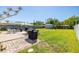 Expansive backyard with lush green grass, mature trees, a shed, and a patio area at 2016 Culberson Ave, Dunedin, FL 34698