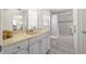 Updated bathroom features modern vanity, shower over bath with grey tiling and contemporary fixtures at 2016 Culberson Ave, Dunedin, FL 34698