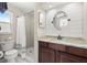 Updated bathroom featuring stylish vanity, framed mirror, and walk-in shower with neutral tiling at 2016 Culberson Ave, Dunedin, FL 34698