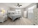 Bright bedroom with neutral tones, offering ample natural light and wood-look flooring at 2016 Culberson Ave, Dunedin, FL 34698