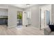 Inviting entryway with light wood floors, neutral walls, and a view into the screened porch at 2016 Culberson Ave, Dunedin, FL 34698