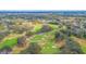 Expansive aerial view of lush green golf course featuring mature trees and manicured greens at 2016 Culberson Ave, Dunedin, FL 34698