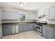 This kitchen boasts stainless steel appliances and two-tone cabinets, with a window over the sink at 2016 Culberson Ave, Dunedin, FL 34698