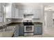 Close up on kitchen featuring stainless steel appliances, two-tone cabinets, and window lighting at 2016 Culberson Ave, Dunedin, FL 34698